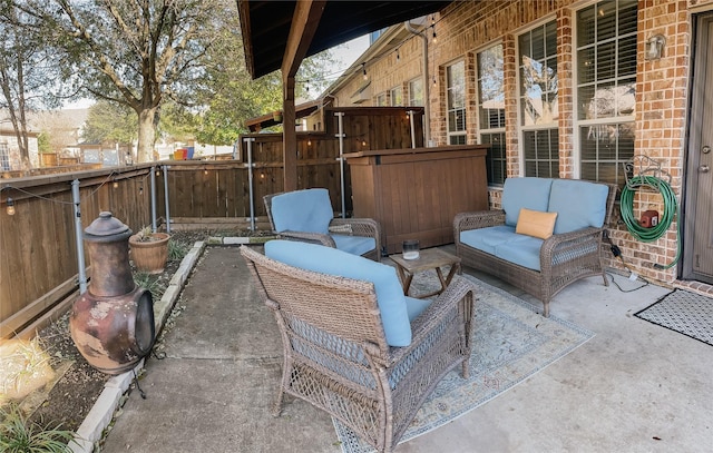 view of patio with outdoor lounge area and fence