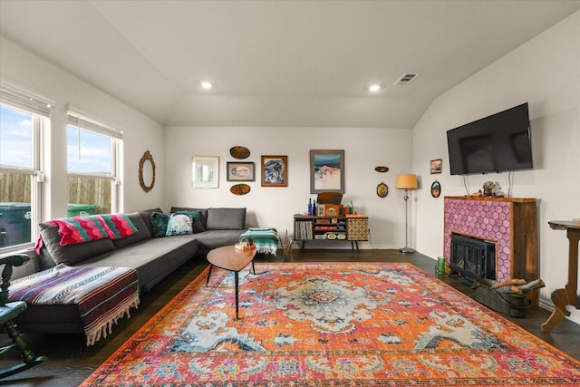 1417 Briar Hl, Denton, TX 76207 - living area with lofted ceiling, wood finished floors, a tiled fireplace, recessed lighting, and baseboards