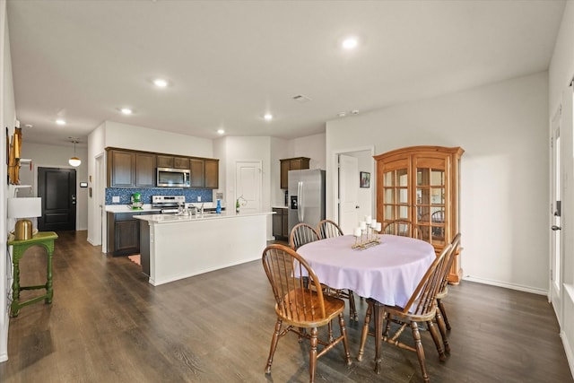 1417 Briar Hl, Denton, TX 76207 - dining space featuring dark wood-style flooring, recessed lighting, and baseboards