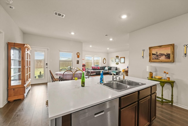 1417 Briar Hl, Denton, TX 76207 - kitchen with dishwasher, a sink, dark wood-style flooring, open floor plan, and light countertops