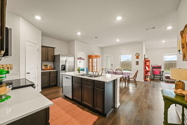 1417 Briar Hl, Denton, TX 76207 - kitchen featuring appliances with stainless steel finishes, a sink, light countertops, dark wood-type flooring, and dark brown cabinetry