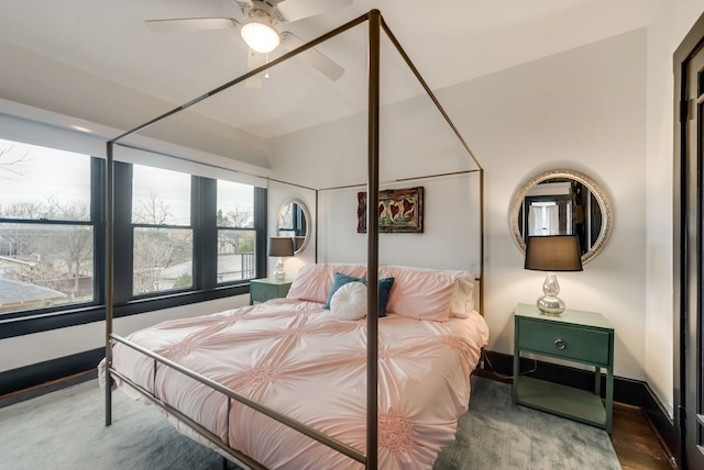 bedroom with a ceiling fan and baseboards