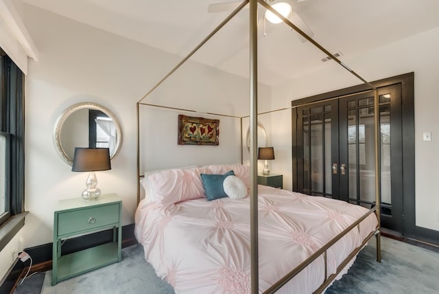 carpeted bedroom featuring visible vents and a ceiling fan