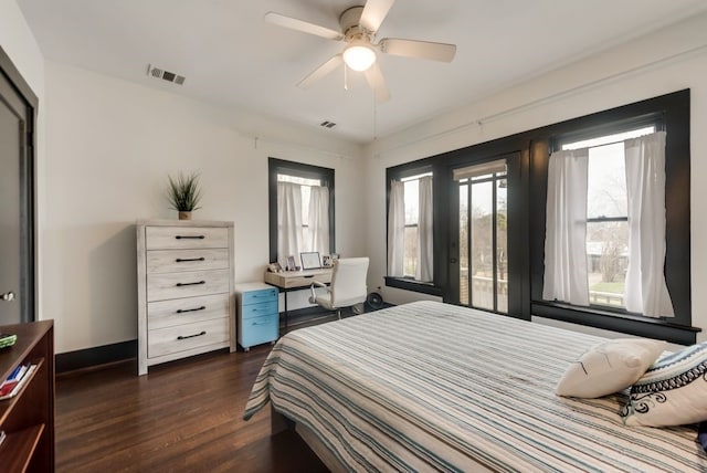 bedroom with baseboards, visible vents, ceiling fan, and dark wood-style flooring
