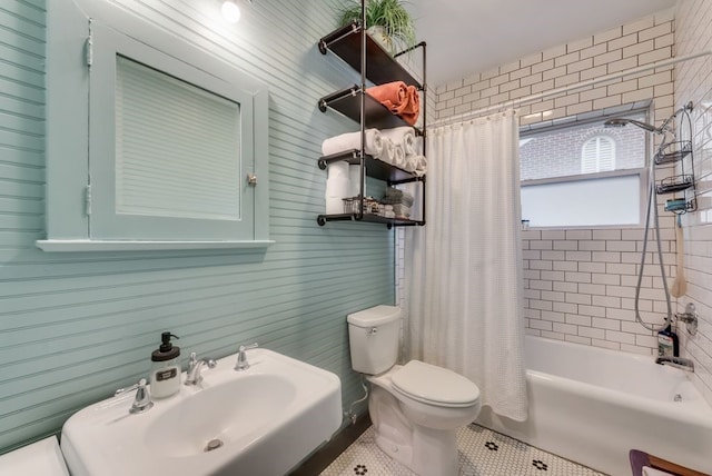 bathroom with shower / bath combo, toilet, tile patterned flooring, and a sink