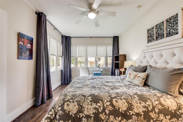 bedroom with baseboards, wood finished floors, and a ceiling fan