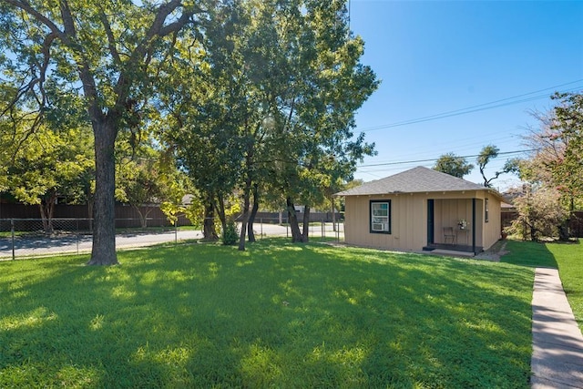view of yard featuring an outdoor structure and a fenced backyard