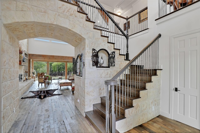 11588 Wild Rose Ln, Anna, TX 75409 - entryway featuring stairway, arched walkways, wood-type flooring, and a towering ceiling