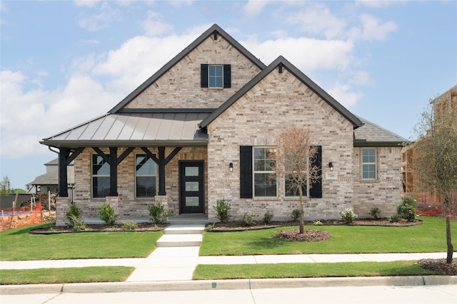7306 Mallow Way, Venus, TX 76084 - view of front facade with a front yard, brick siding, and a standing seam roof