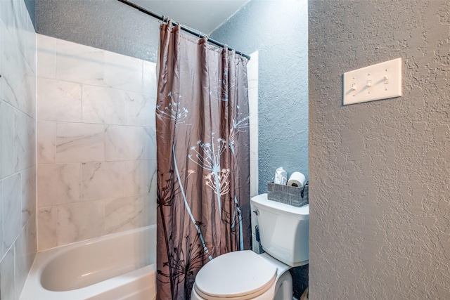 bathroom featuring shower / bath combo, toilet, and a textured wall
