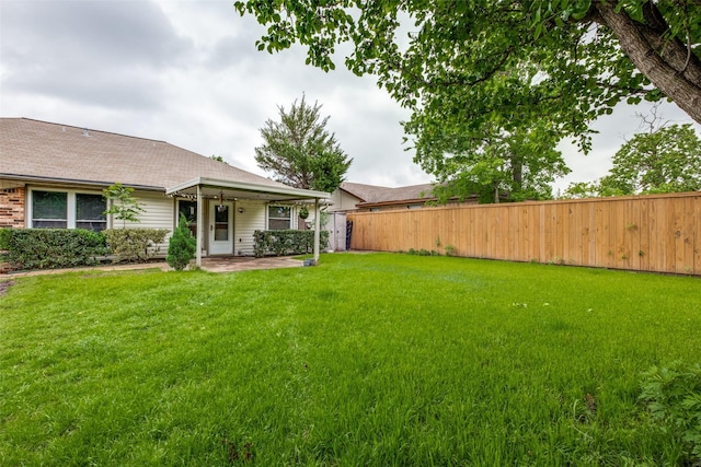 view of yard with fence and a patio area