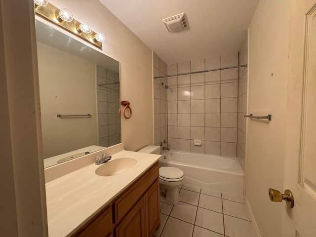 bathroom featuring tile patterned flooring, toilet, vanity, visible vents, and washtub / shower combination