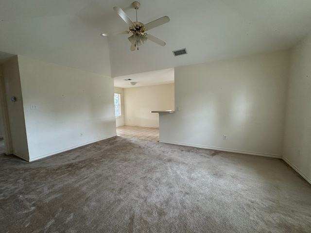 unfurnished room with carpet flooring, ceiling fan, high vaulted ceiling, visible vents, and baseboards