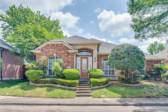 942 Lexington Dr, Rockwall, TX 75087 - view of front of home featuring a front lawn, a shingled roof, and brick siding