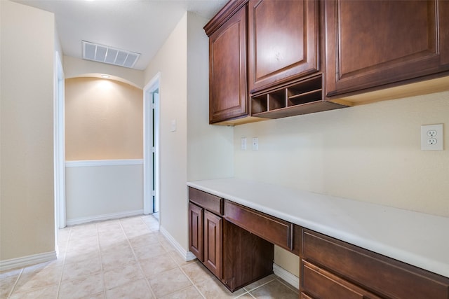 942 Lexington Dr, Rockwall, TX 75087 - interior space featuring light countertops, light tile patterned flooring, visible vents, built in study area, and baseboards