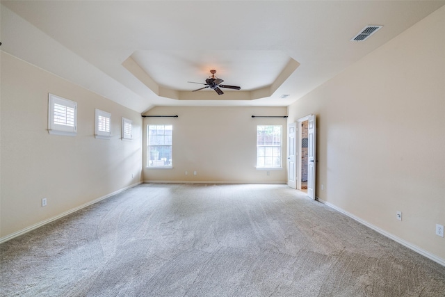 942 Lexington Dr, Rockwall, TX 75087 - carpeted spare room featuring visible vents, a raised ceiling, a ceiling fan, and plenty of natural light