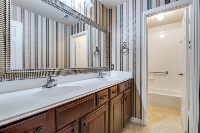 942 Lexington Dr, Rockwall, TX 75087 - bathroom featuring tile patterned floors, visible vents, double vanity, and a sink