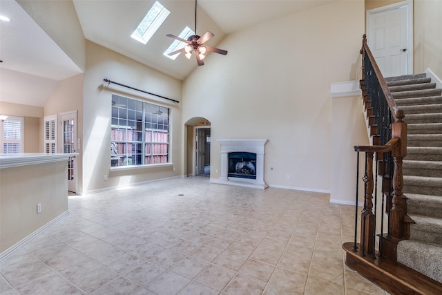 942 Lexington Dr, Rockwall, TX 75087 - unfurnished living room featuring tile patterned floors, ceiling fan, stairs, and a fireplace with raised hearth
