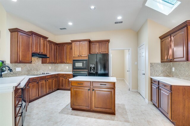 942 Lexington Dr, Rockwall, TX 75087 - kitchen featuring black appliances, a skylight, visible vents, and under cabinet range hood