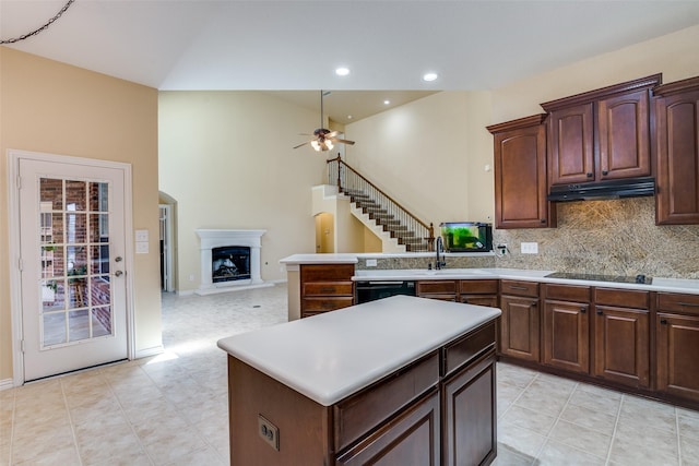 942 Lexington Dr, Rockwall, TX 75087 - kitchen with decorative backsplash, ceiling fan, light countertops, under cabinet range hood, and black appliances