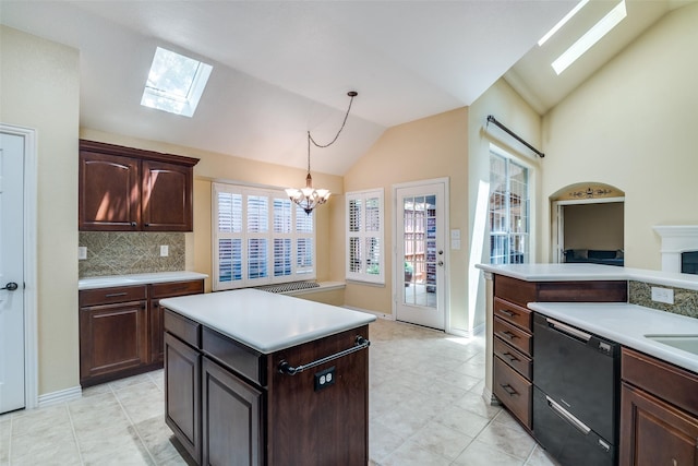942 Lexington Dr, Rockwall, TX 75087 - kitchen with an inviting chandelier, hanging light fixtures, vaulted ceiling with skylight, light countertops, and dishwasher
