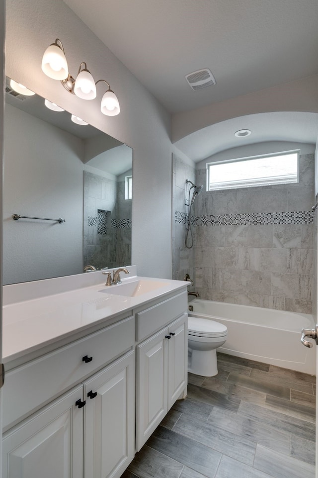 full bathroom featuring shower / tub combination, toilet, visible vents, and vanity