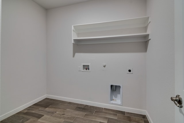 clothes washing area with gas dryer hookup, electric dryer hookup, baseboards, hookup for a washing machine, and laundry area