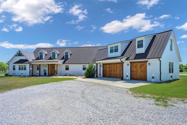 view of front of home featuring driveway, a standing seam roof, and metal roof