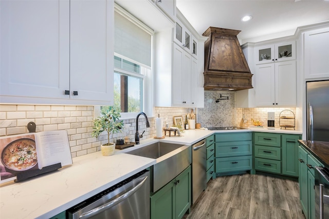 kitchen featuring custom exhaust hood, green cabinetry, white cabinets, and stainless steel appliances