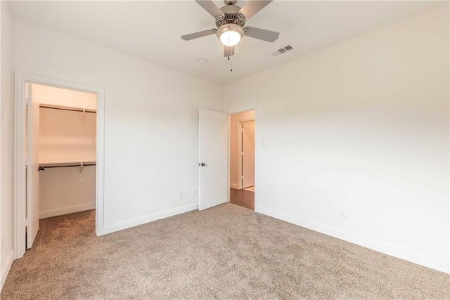 10169 Budtime Ln, Dallas, TX 75217 - unfurnished bedroom with carpet flooring, baseboards, visible vents, and a walk in closet