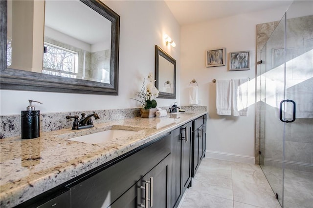 10169 Budtime Ln, Dallas, TX 75217 - bathroom featuring double vanity, a shower stall, a sink, baseboards, and marble finish floor