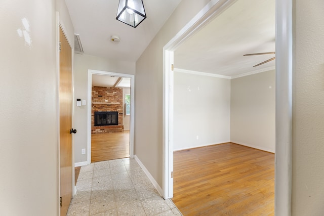 hallway featuring visible vents and baseboards