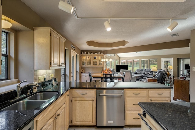 kitchen with track lighting, light brown cabinets, dishwasher, and a sink