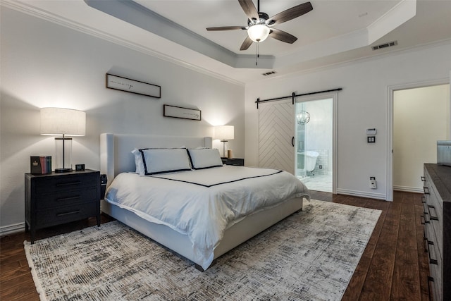 bedroom featuring hardwood / wood-style floors, visible vents, a raised ceiling, and ornamental molding