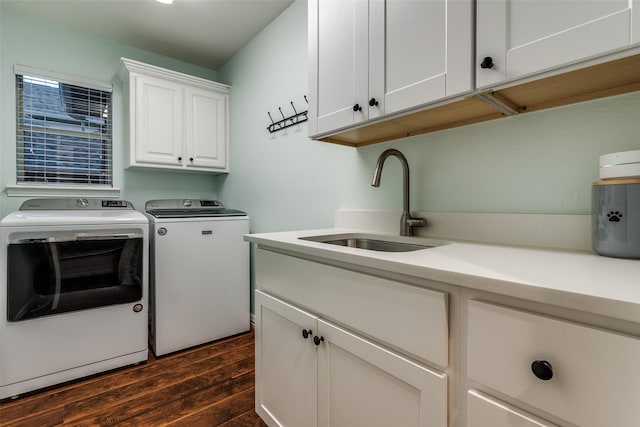 laundry room featuring a sink, separate washer and dryer, cabinet space, and dark wood-style flooring