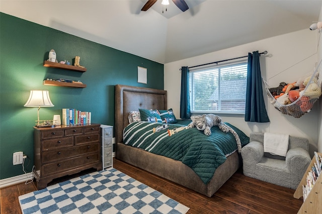 bedroom with wood finished floors, a ceiling fan, vaulted ceiling, and baseboards