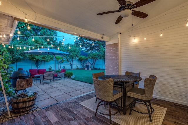 view of patio featuring an outdoor living space, a fenced backyard, a ceiling fan, and outdoor dining area