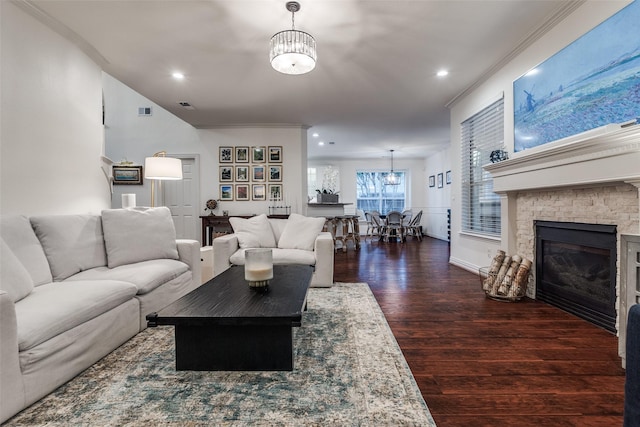 living area featuring recessed lighting, an inviting chandelier, a stone fireplace, dark wood-style flooring, and visible vents