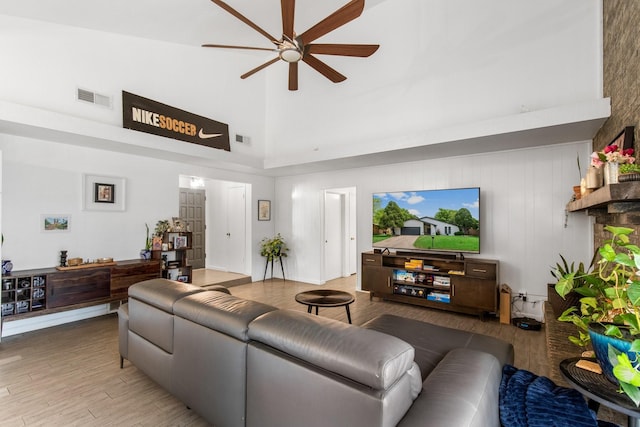 2409 Leslie St, Denton, TX 76205 - living room with ceiling fan, visible vents, a high ceiling, and light wood-type flooring