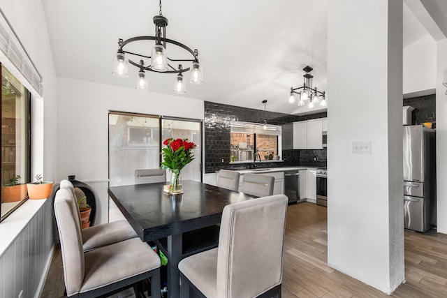 2409 Leslie St, Denton, TX 76205 - dining space featuring light wood-style flooring and a notable chandelier