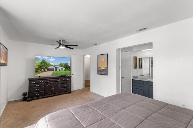 2409 Leslie St, Denton, TX 76205 - carpeted bedroom featuring baseboards, visible vents, ceiling fan, and ensuite bath