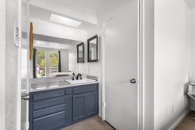 2409 Leslie St, Denton, TX 76205 - bathroom with a skylight and vanity
