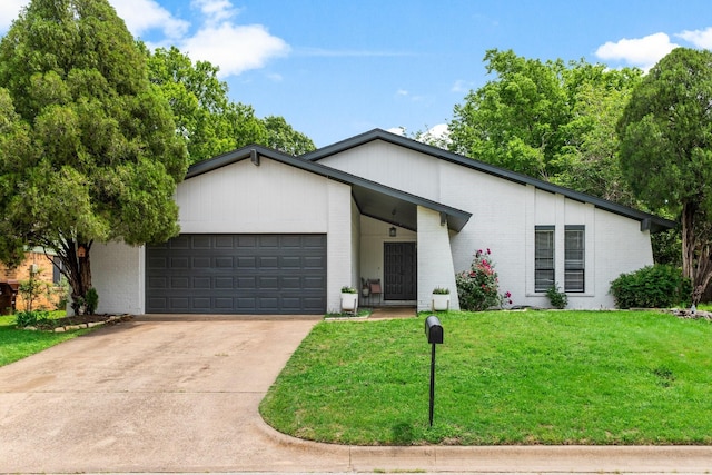 2409 Leslie St, Denton, TX 76205 - single story home featuring concrete driveway, brick siding, an attached garage, and a front lawn