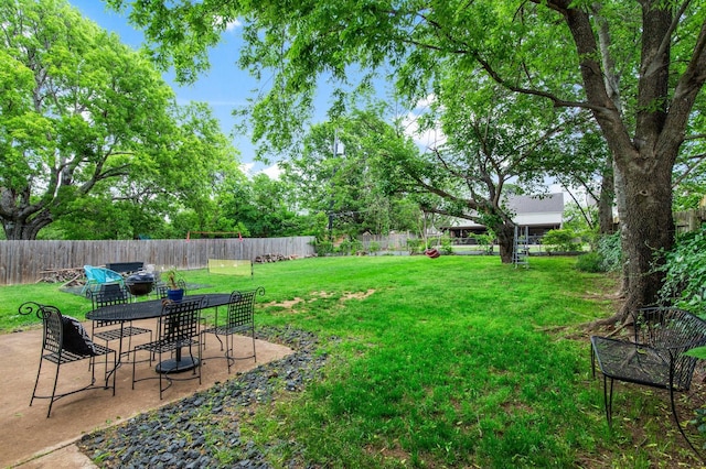 2409 Leslie St, Denton, TX 76205 - view of yard featuring outdoor dining area, a fenced backyard, and a patio area