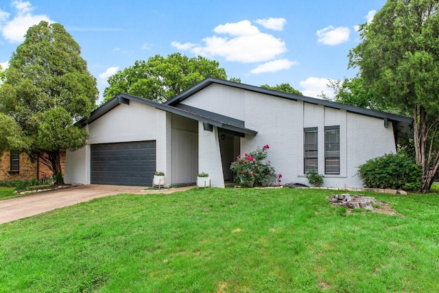 2409 Leslie St, Denton, TX 76205 - mid-century modern home with brick siding, a garage, a front lawn, and concrete driveway