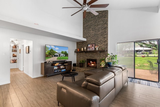 2409 Leslie St, Denton, TX 76205 - living room featuring ceiling fan, a fireplace, high vaulted ceiling, baseboards, and wood finished floors