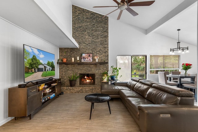 2409 Leslie St, Denton, TX 76205 - living area featuring beam ceiling, light wood finished floors, a brick fireplace, high vaulted ceiling, and ceiling fan with notable chandelier