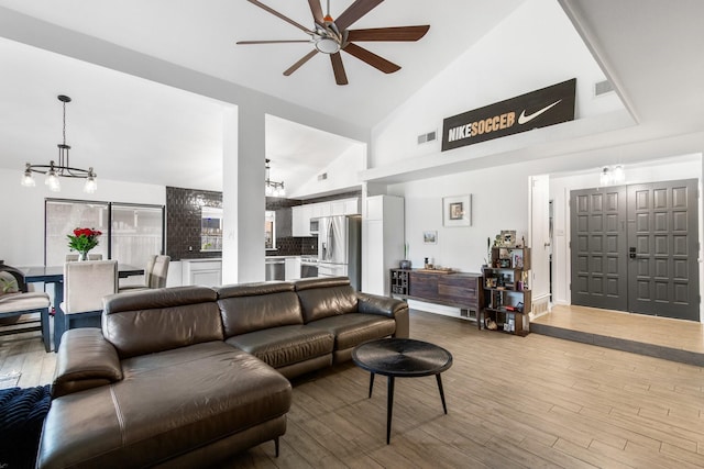 2409 Leslie St, Denton, TX 76205 - living area featuring high vaulted ceiling, ceiling fan with notable chandelier, wood finished floors, and visible vents
