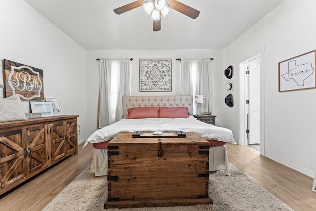 bedroom featuring baseboards, a ceiling fan, and light wood finished floors