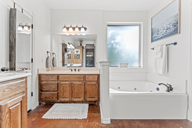 bathroom featuring a tub with jets and vanity
